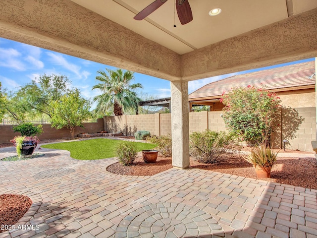 view of patio featuring ceiling fan