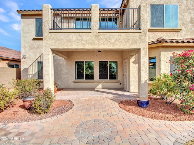 exterior space with a balcony and a patio