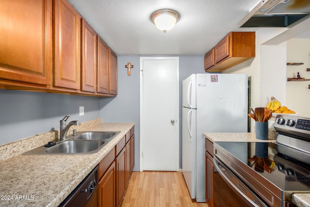 kitchen featuring a textured ceiling, electric range, ventilation hood, sink, and light wood-type flooring