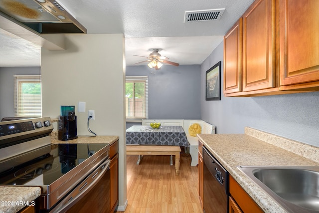 kitchen with light wood-type flooring, stainless steel electric range, dishwasher, sink, and ceiling fan