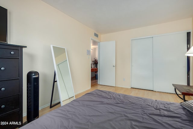 bedroom featuring light wood-type flooring and a closet