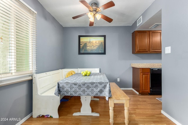 dining area with light hardwood / wood-style flooring and ceiling fan