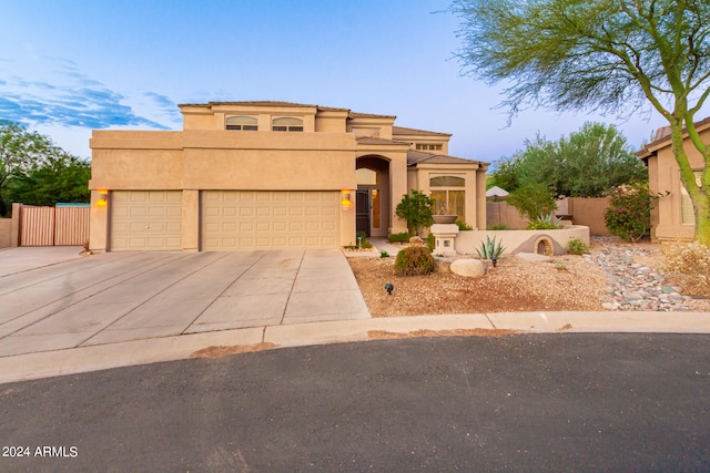 pueblo-style home featuring a garage