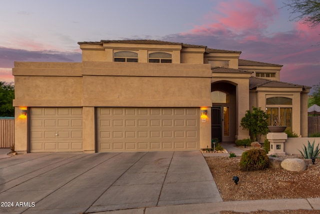 mediterranean / spanish-style home featuring a garage