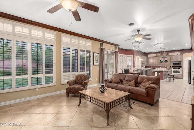 living room featuring ornamental molding, ceiling fan, and light tile patterned floors