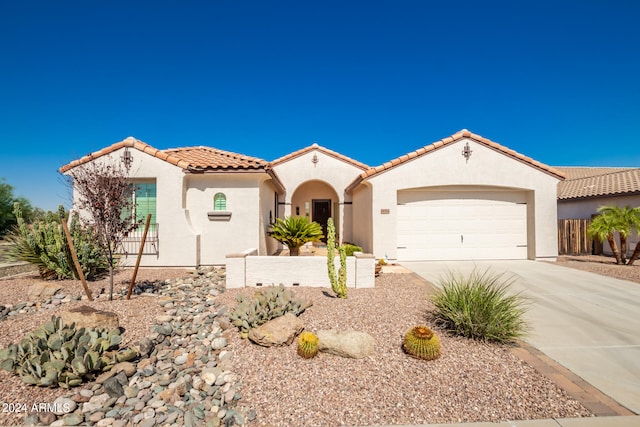 mediterranean / spanish-style home with a garage