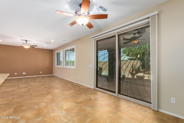 tiled empty room featuring ceiling fan