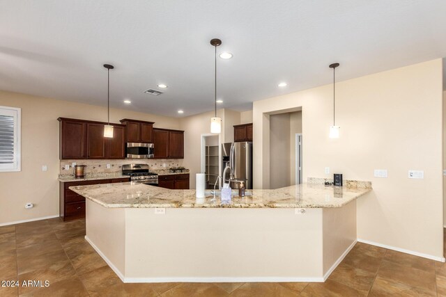 kitchen with a peninsula, stainless steel appliances, tasteful backsplash, and light stone counters