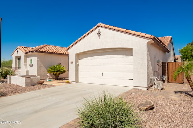 mediterranean / spanish-style home with a garage