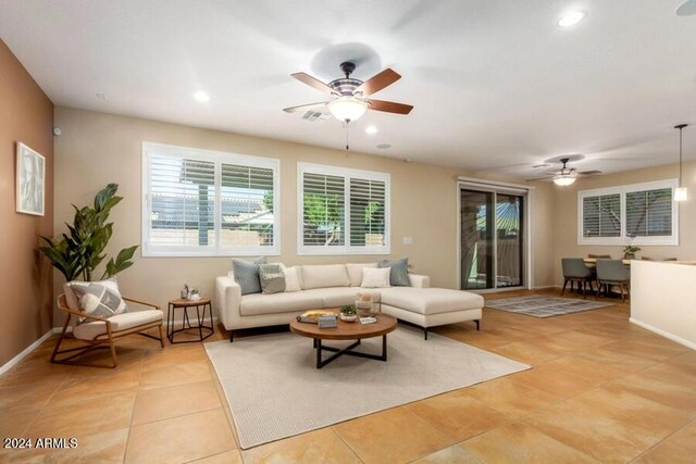 living room with baseboards, recessed lighting, light tile patterned floors, and a ceiling fan