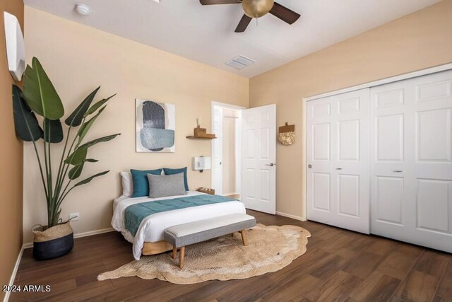bedroom featuring a closet, a ceiling fan, wood finished floors, baseboards, and visible vents