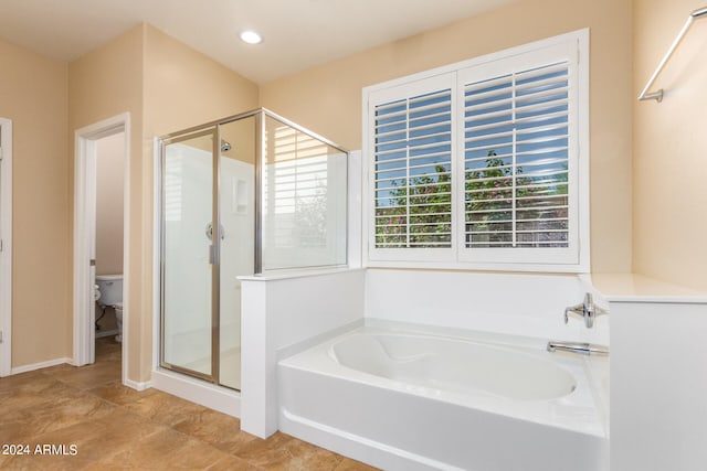 bathroom with toilet and separate shower and tub