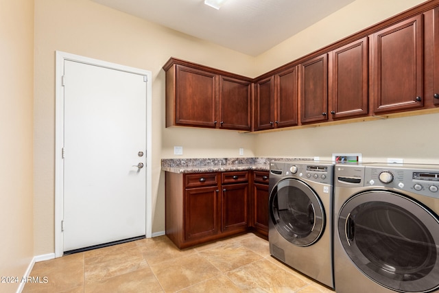 washroom with cabinets, separate washer and dryer, and light tile patterned floors