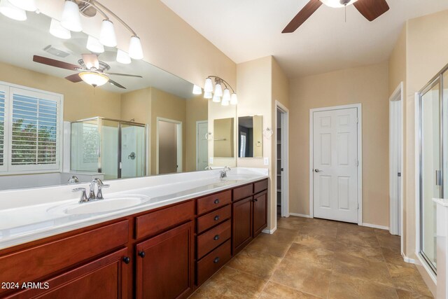 bathroom featuring a sink, a shower stall, visible vents, and ceiling fan