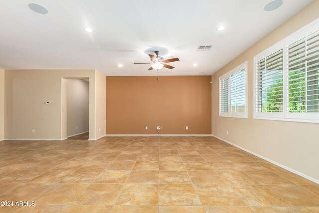 empty room with baseboards, ceiling fan, visible vents, and recessed lighting