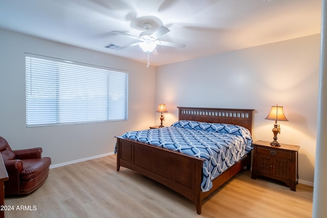 bedroom with ceiling fan and light hardwood / wood-style floors