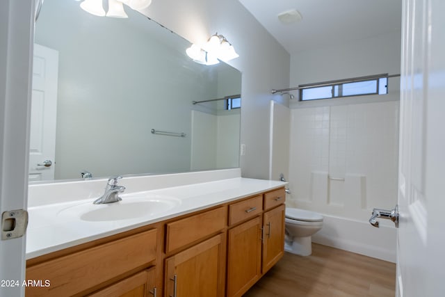 full bathroom featuring wood-type flooring, vanity, toilet, and shower / washtub combination