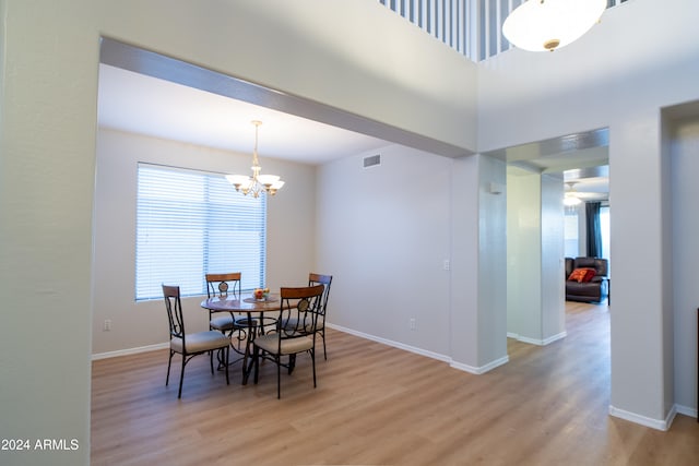 dining space featuring an inviting chandelier and light wood-type flooring