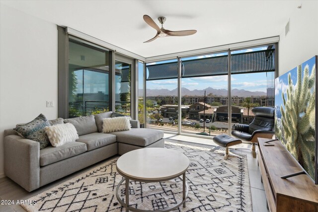 sunroom / solarium with a mountain view and ceiling fan