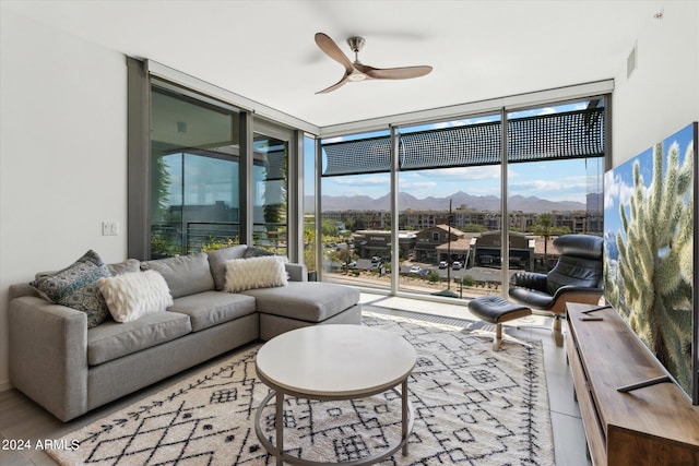 living room with expansive windows and ceiling fan