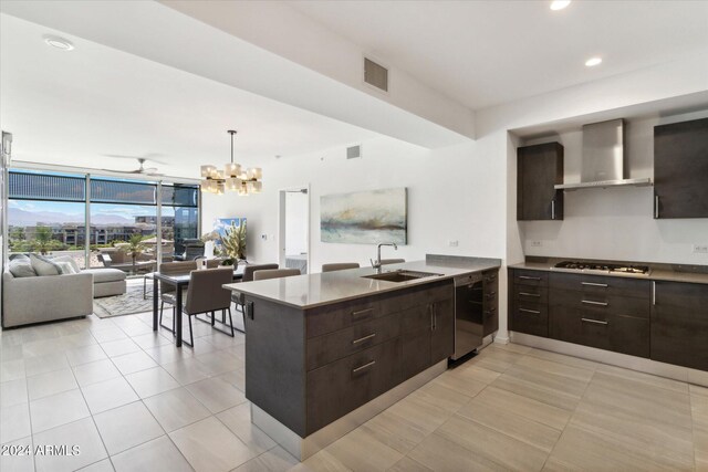 kitchen featuring black dishwasher, wall chimney range hood, sink, dark brown cabinetry, and white gas cooktop