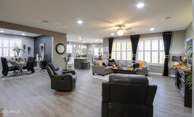 living room with ceiling fan and light hardwood / wood-style floors