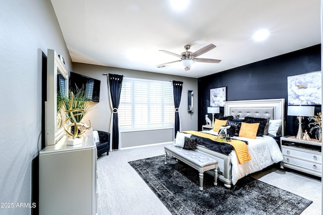 bedroom featuring light colored carpet and ceiling fan