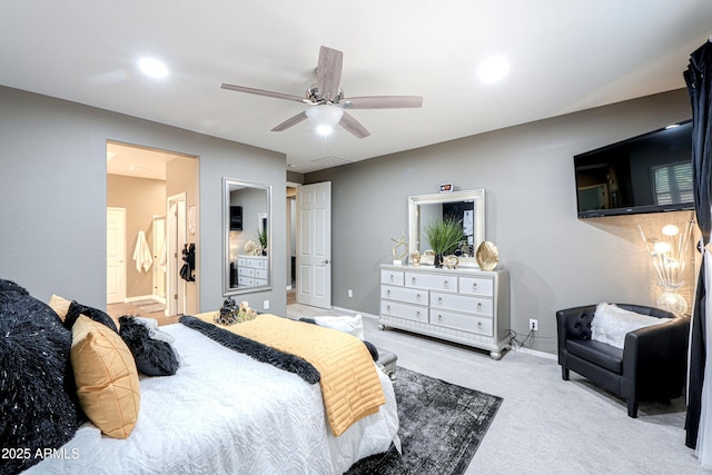 bedroom with ceiling fan, connected bathroom, and light carpet