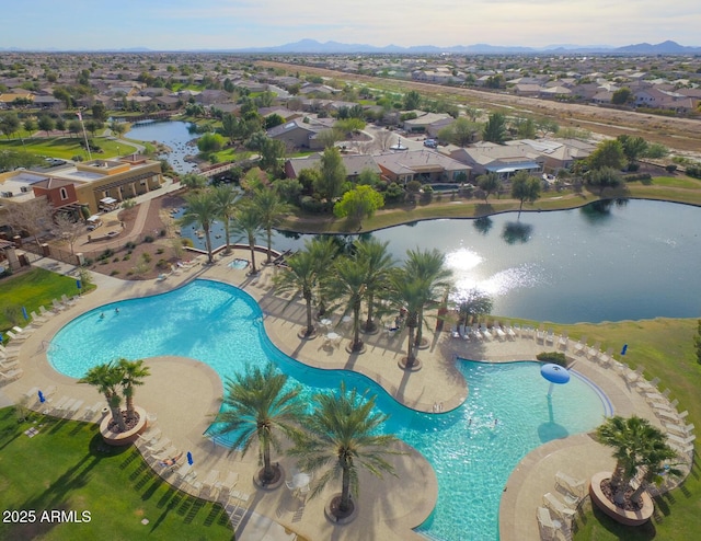 view of pool with a water and mountain view and a patio area