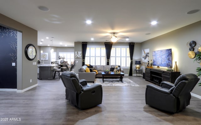 living room featuring hardwood / wood-style floors and ceiling fan