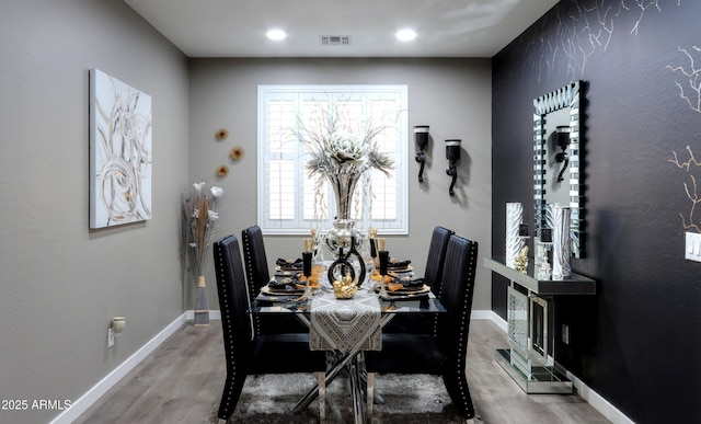 dining space featuring wood-type flooring