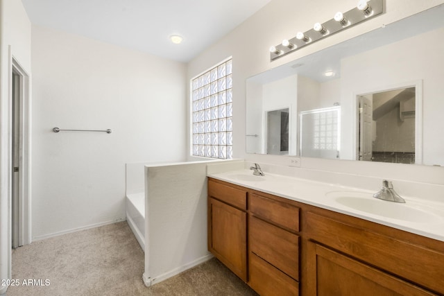 full bath featuring a garden tub, double vanity, a shower with shower door, and a sink