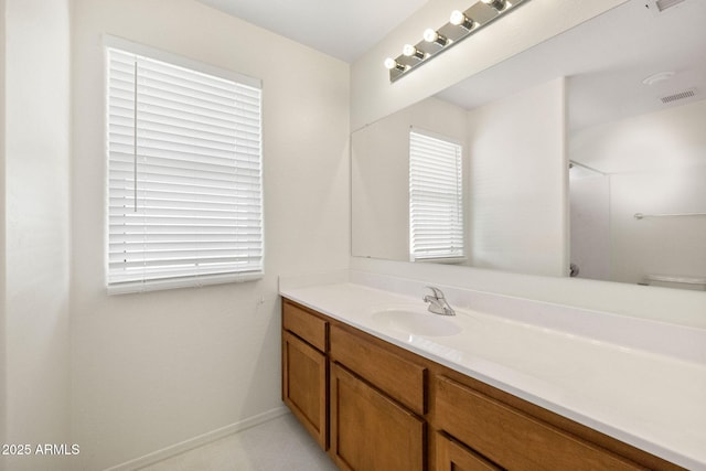 bathroom featuring tile patterned floors, visible vents, baseboards, and vanity