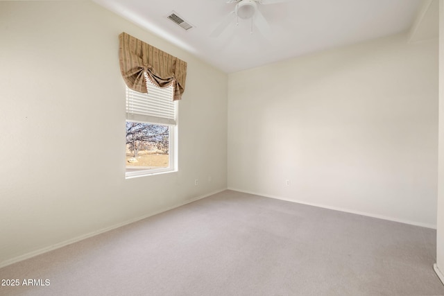 empty room with visible vents, carpet flooring, baseboards, and ceiling fan