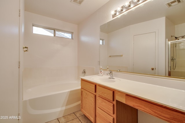 bathroom featuring tile patterned flooring, vanity, and separate shower and tub