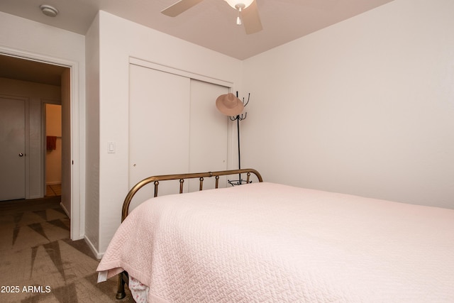 carpeted bedroom with ceiling fan and a closet