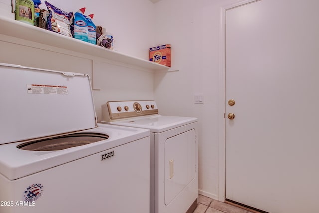 washroom featuring light tile patterned floors and washer and dryer