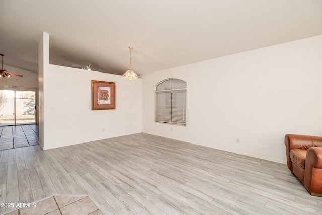 unfurnished living room featuring lofted ceiling, light hardwood / wood-style floors, and ceiling fan