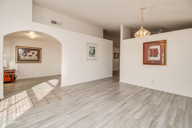 interior space with light hardwood / wood-style flooring and a high ceiling