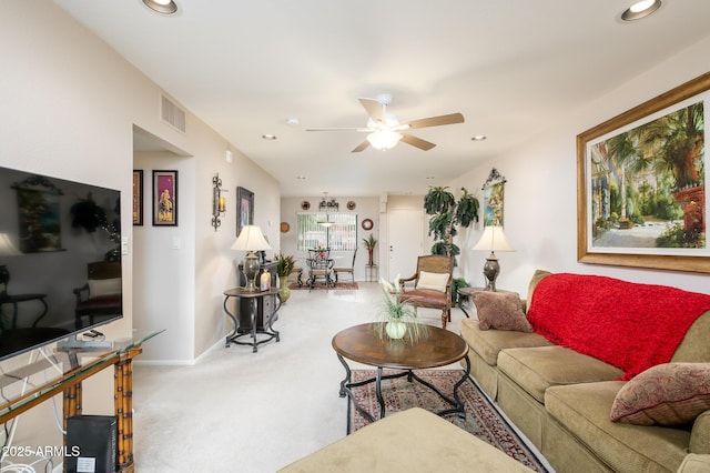 carpeted living room featuring ceiling fan