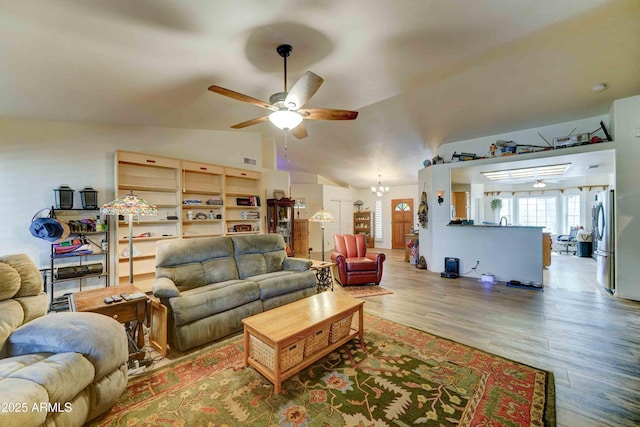 1704 S Barkley Rd, Apache Junction, AZ 85119 - living room with a ceiling fan, lofted ceiling, wood finished floors, and a chandelier