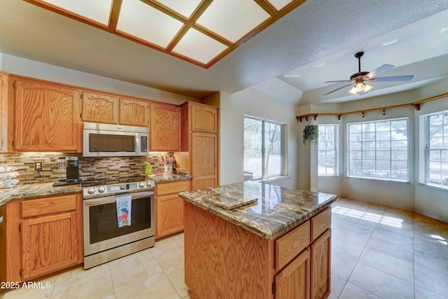 1704 S Barkley Rd, Apache Junction, AZ 85119 - kitchen with appliances with stainless steel finishes, healthy amount of natural light, decorative backsplash, and a center island