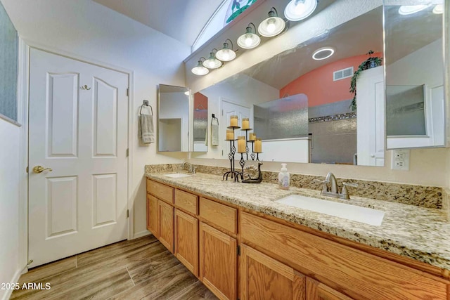 1704 S Barkley Rd, Apache Junction, AZ 85119 - bathroom with double vanity, walk in shower, and wood finished floors