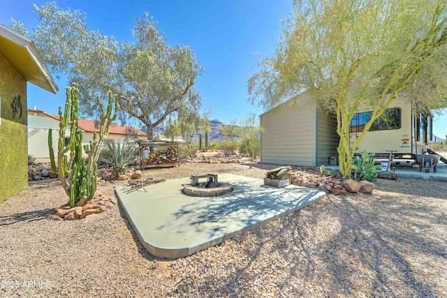 1704 S Barkley Rd, Apache Junction, AZ 85119 - view of yard with a patio and a fire pit