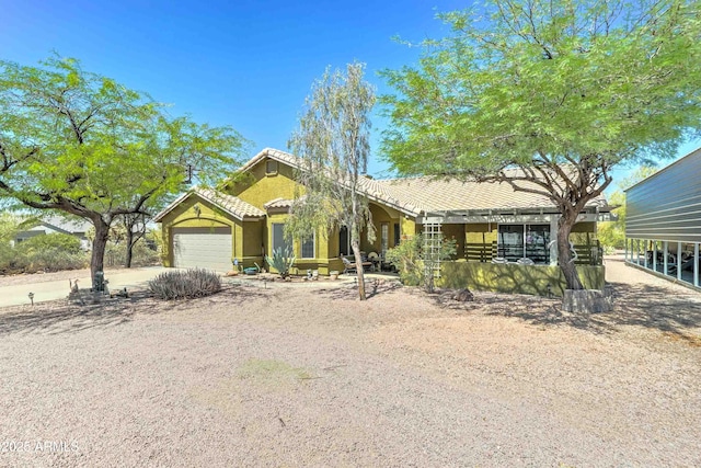 1704 S Barkley Rd, Apache Junction, AZ 85119 - view of front of home featuring a garage, a tile roof, and stucco siding