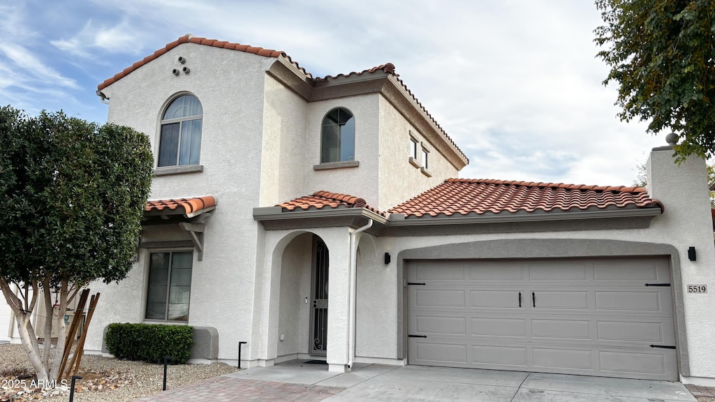 mediterranean / spanish-style home featuring a garage