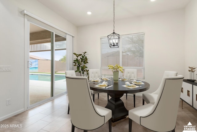 dining room featuring recessed lighting, baseboards, and an inviting chandelier