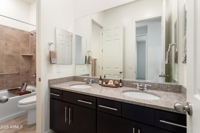 full bath with double vanity, toilet, tub / shower combination, and a sink