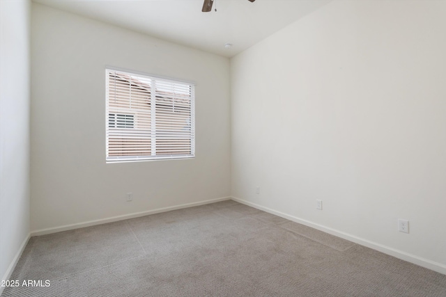 unfurnished room with baseboards, light carpet, and ceiling fan