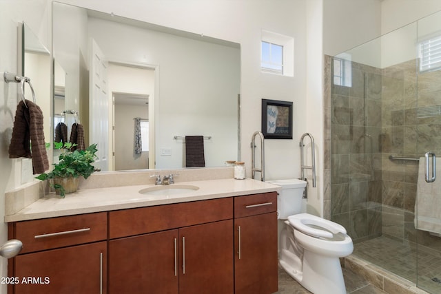 full bath with vanity, a shower stall, toilet, and a wealth of natural light